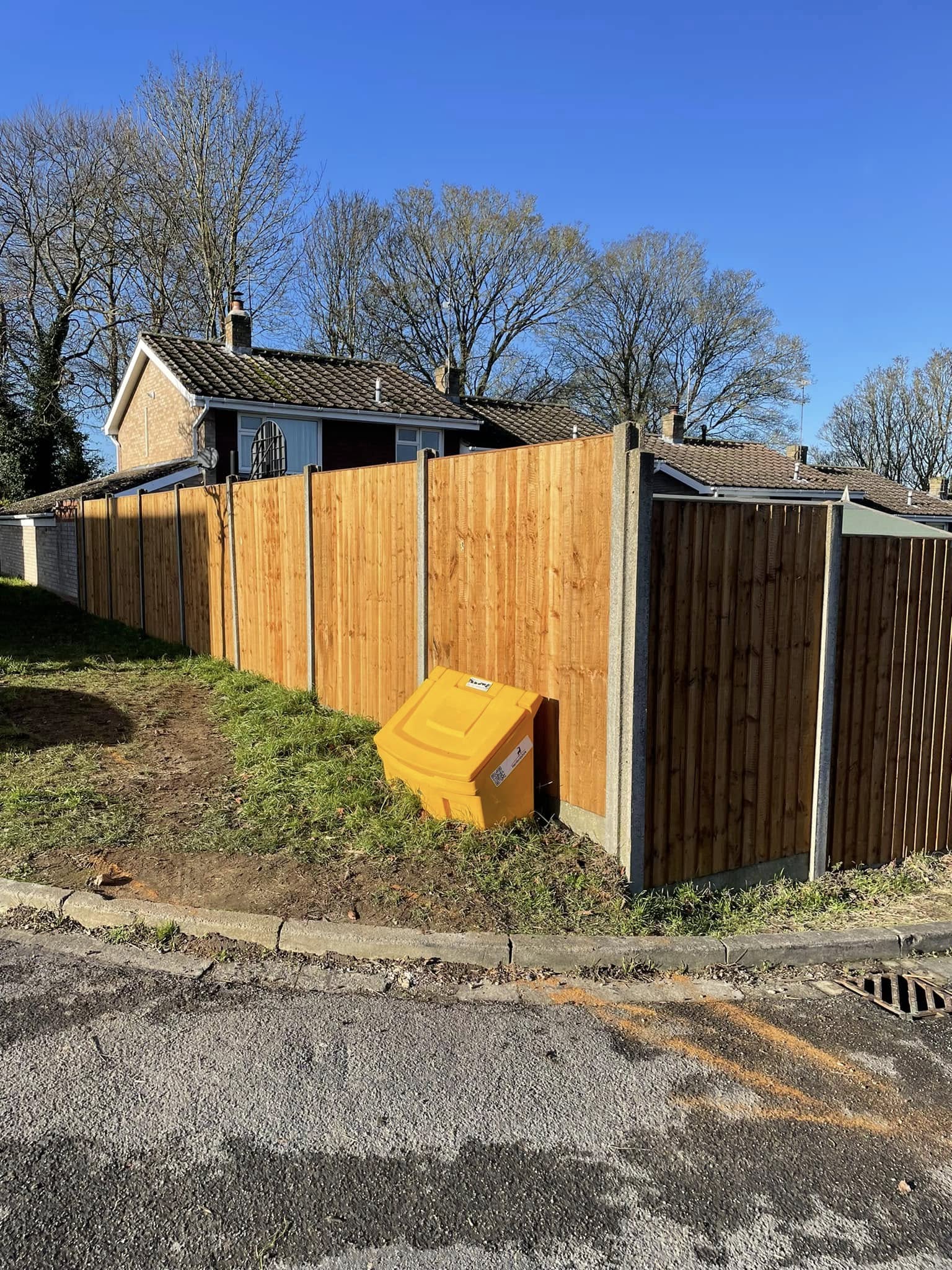 Wooden edge fencing installed along a residential garden boundary